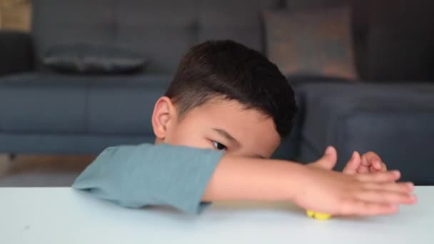 Little asian preschooler engaged in creativity. Boy winks and forms a shape on the table — Vídeo de Stock