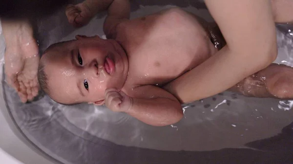 Top view of mother washing babys head and face — Stock Photo, Image