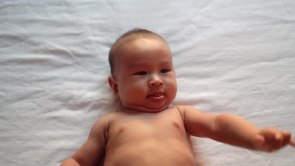 Cute Asian Baby Smiling Lying Bed High Quality Footage — Stockvideo