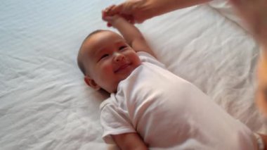 Baby enjoy exercises with his mom. High quality 4k footage
