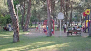 Children are playing and having fun on playground in the park. High quality 4k footage