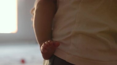 Bebek bacağının görüntüsünü kapat. Anne bebeğini kucağında tutuyor. Yüksek kalite 4k görüntü