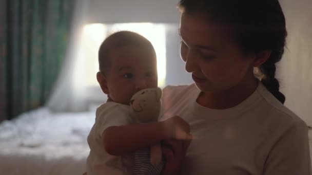 Mother Holds Baby Her Arms Giving Toy High Quality Footage — Stockvideo