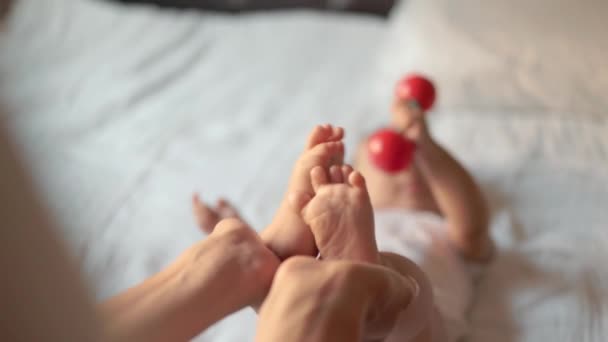 Mother Holds Babys Legs Infant Child Takes Toy High Quality — Stockvideo