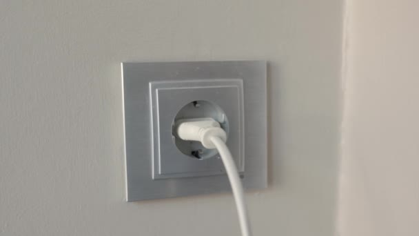 Man Inserts Plug Electrical Socket Wall High Quality Footage — Stockvideo