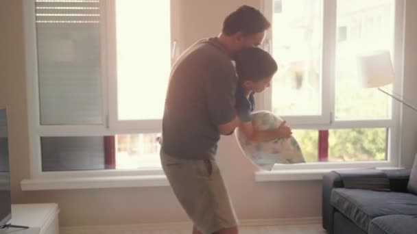 Young Father Little Son Enjoy Pillow Fighting Sit Sofa Home — Stockvideo