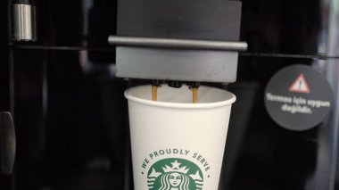 Automatic Coffee machine is pouring a coffee into the take away cup. High quality 4k footage