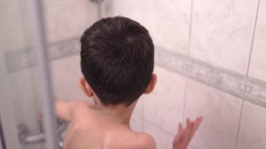 Happy Little preschooler having a shower by himself. High quality 4k footage