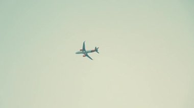 Airplane flies into clouds on grey sky. High quality 4k footage