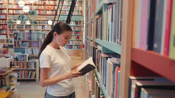 Young Woman Leafing Book Library University Public Library Office Bookshelves — Stockvideo