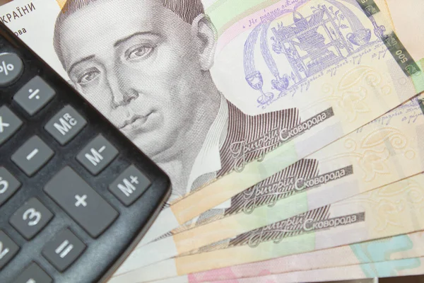 canculator and ukrainian hryvnia closeup, ukrainian currency