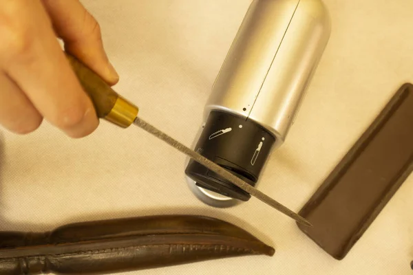 sharpening an antique knife with an electric grinder, high carbon steel