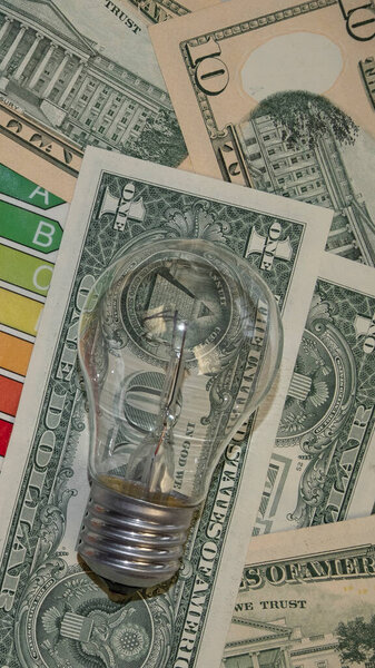 incandescent lamp, energy efficiency on dolors background