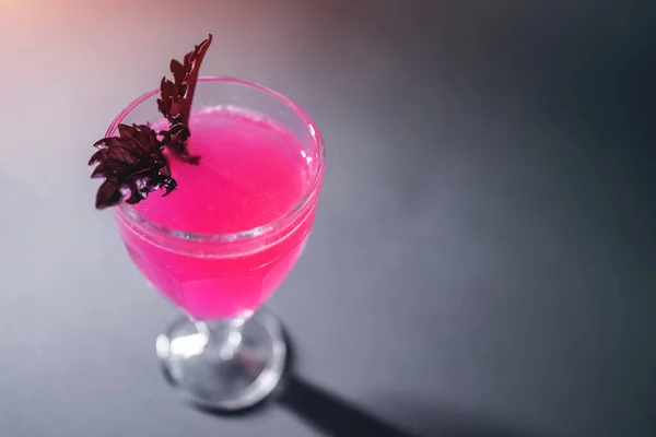 Bebida cocktail de luxo com álcool rosa com manjericão em vidro sobre fundo cinzento — Fotografia de Stock
