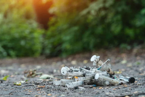 Uyuşturucu enjekte edildikten sonra açık havada bırakılmış bir sürü kirli şırınga.