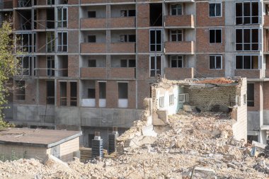 Modern gökdelenin yeni inşaatı yakınlarındaki eski binanın yıkımı