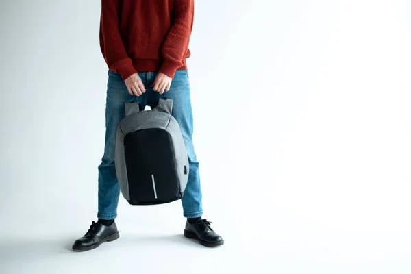 Стильный хипстер мужчина держа современный рюкзак сумка на белом фоне — стоковое фото