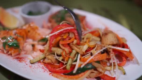 Close-up de mão com garfo comer salada com cenoura ralada, pimentão e cogumelo — Vídeo de Stock