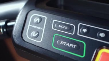 close up of training machine console with key menu for start exercising