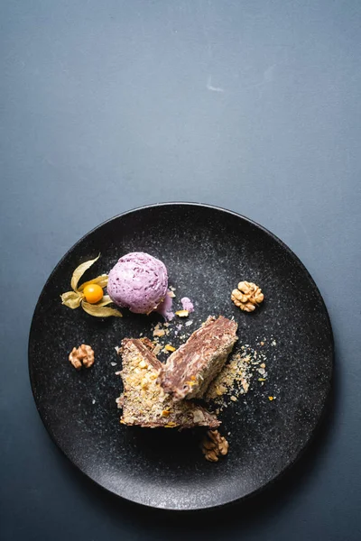 Stock image closeup of chocolate napoleon with puff pastry and nut cream on grey background