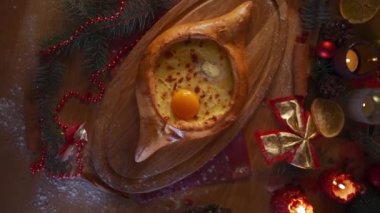 national georgia adjara hachapuri at chrismas table, top view flatlay