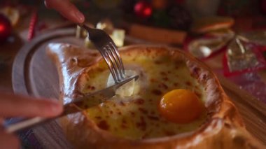 hand with fork mix national georgia adjara hachapuri at chrismas table