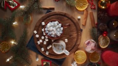 warm delicious cacao mug with sweets on wood board at new year eve, top view