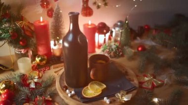 gluhwine and mulled wine with orange, anise, vintage bottle at cozy new year eve