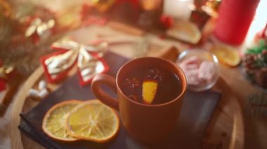 gluhwine and mulled wine with citrus, anise, vintage mug at cozy new year eve
