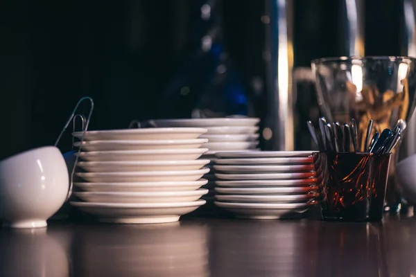 shiny porcelain plate collection on bar counter