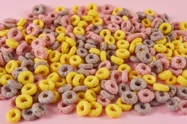 Pembe arkaplanda pullu halkalar var.