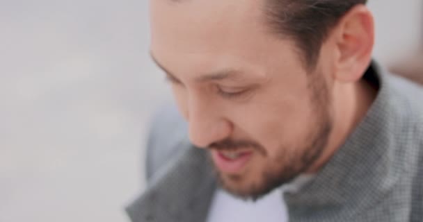 Close up of young men face, with mustaches and a beard, who is smooting the — стоковое видео