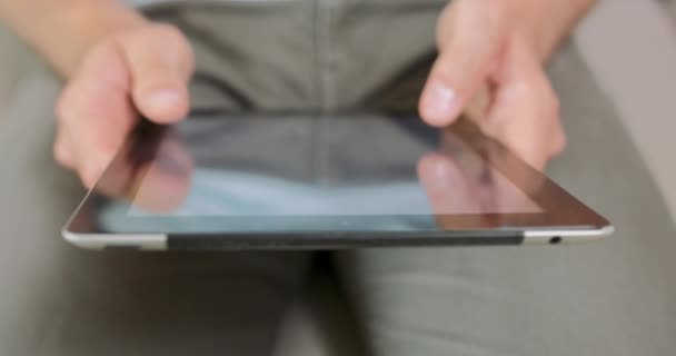 Closup of mans hands and palms, while he is holding and using tablet, probably playing a game or scrolling something His hands, palms are blurred — Stock Video