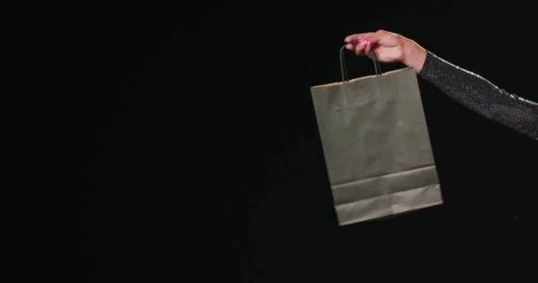 Someone holding up a shopping bag on Black Friday — Stock Video