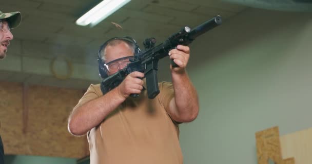 The stressed student fires the first shot from the rifle at the shooting range — Stock Video