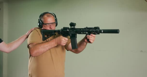 The stressed student fires the first shot from the rifle at the shooting range — Stock Video