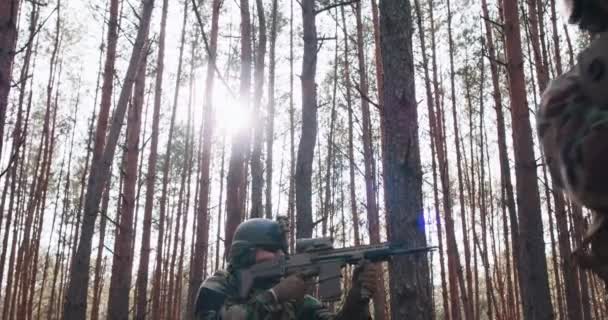 Squad of Fully Equiped Soldiers in Camouflage on a Reconnaissance Military Mission Rifles Ready to Shoot Theyre Moving in Formation Through Dense Forest — Video Stock