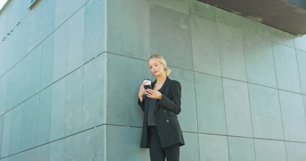 Abogado - joven mujer blanca abogado mirando teléfono inteligente móvil y beber café de desechables — Vídeos de Stock