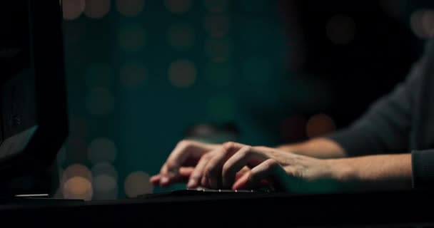 Close up of a young hackers hands writing malware on the computer keyboard in a — Stock video