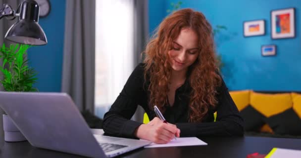 Свободная девушка-подросток в повседневной одежде с использованием ноутбука, работающего по видеосвязи с клиентом в — стоковое видео