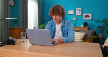 Genç adam odasında bir dizüstü bilgisayarla ders çalışıyor. Yakışıklı bir adamla sohbet ediyor.