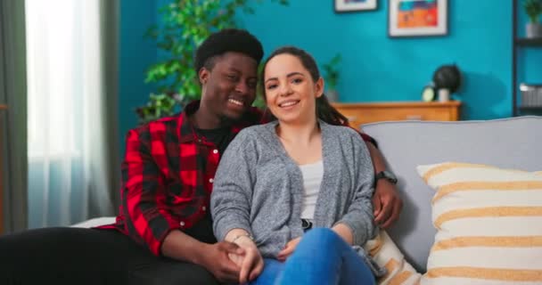 Portrait of smiling black man embrace his wife from behind and looking at camera. Happy — Stock Video
