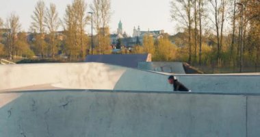 Siyah giysili cesur, genç bir çocuk kafasında bir miğferle yarışıyor.