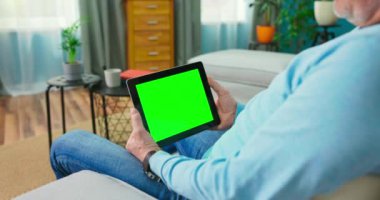 Yaşlı adam talep videosu web sitesinde dizi izliyor. Dijital tableti şununla kapat