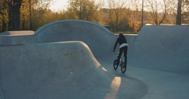 Talented, young, handsome boy dressed in black with a helmet on his head races his — Stock Video