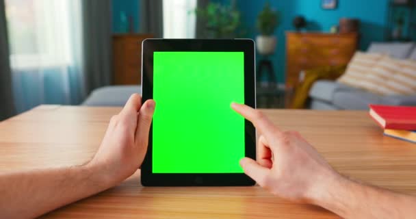 Close-up of Man Using Green Mock-up Screen Digital Tablet Computer in Portrait Mode while Sitting — Stock Video