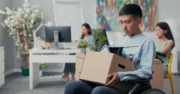 Funktionshindrade ledsna män i skjorta med asiatisk koreansk skönhet sitter i rullstol vid skrivbordet i — Stockvideo