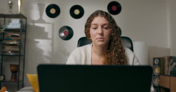 美しい 陽気な女の子 ノートパソコンの画面を見て カレンダーにメモを書く 仲間とビデオカメラを介してチャット オンライン相談 — ストック動画