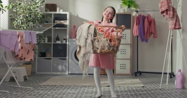 Girl Holds Large Wicker Basket Filled Clothes Wash Smiles Laughs — Vídeo de stock