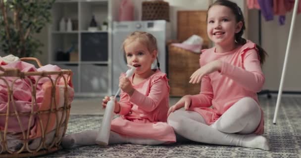 Two Little Girls Pink Dresses Hugging Talking Playing Sitting Laundry — Vídeos de Stock